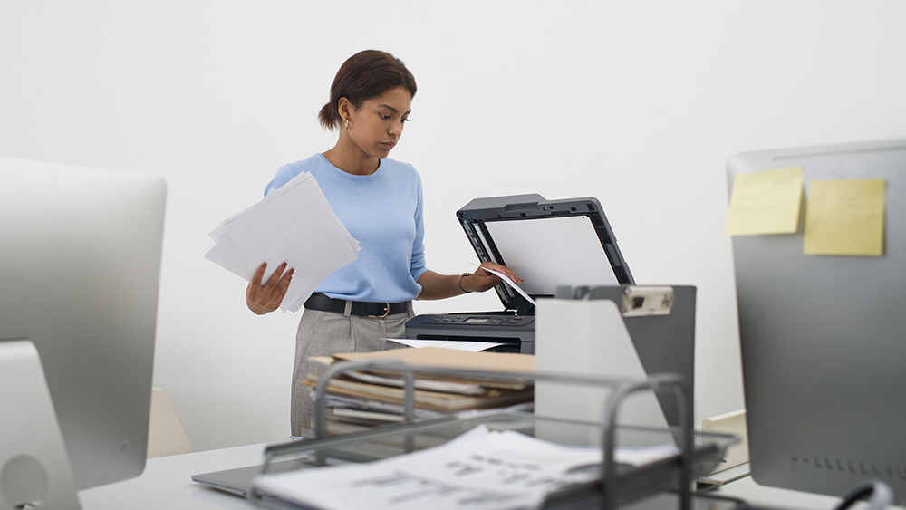 Girl scanning documents in a large office