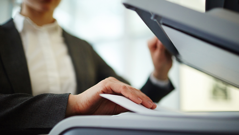 Girl scanning a document on a scanner