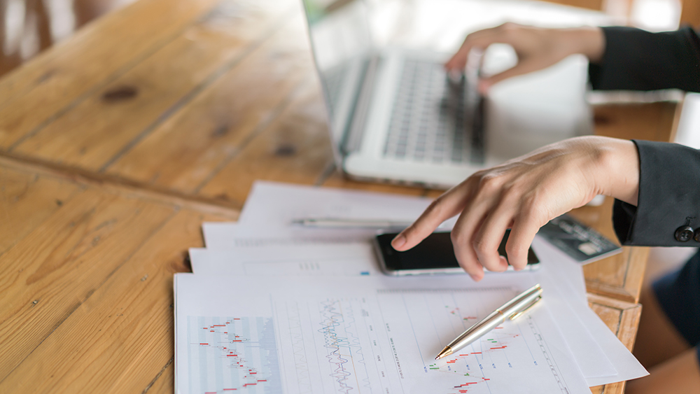 A woman works with financial documents