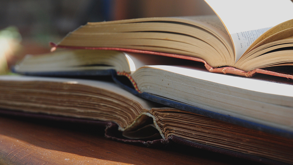 Three old books on a table